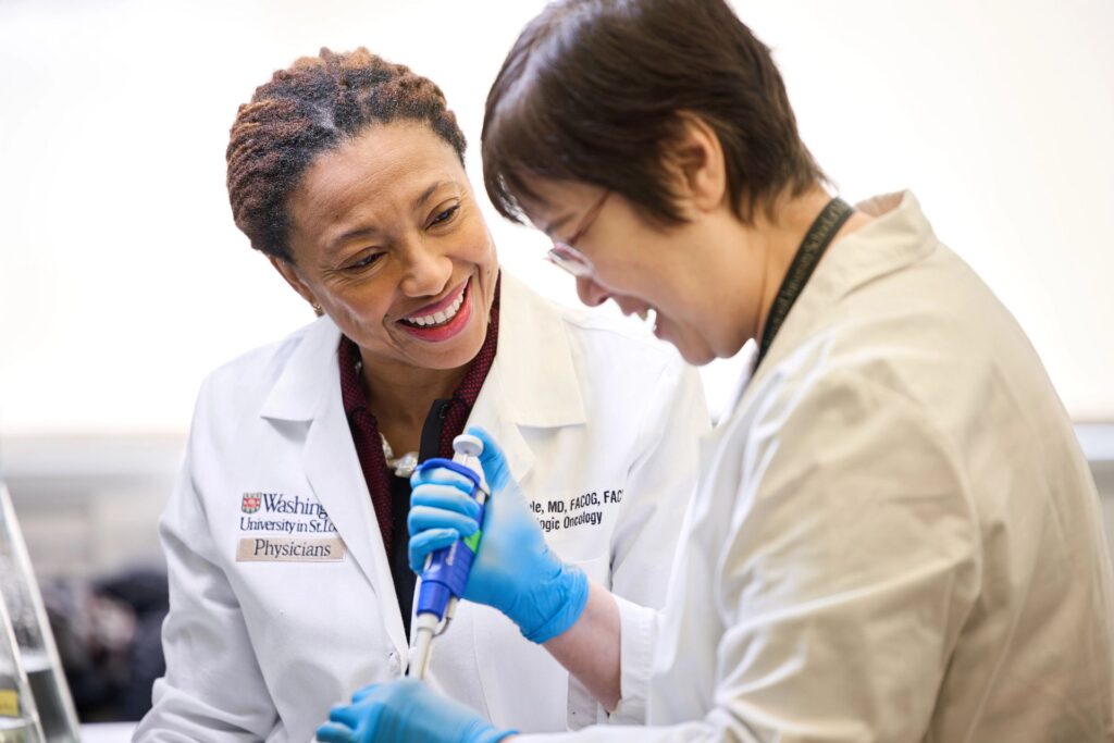 Dineo Khabele, MD, works with research technician Wendy Zhang in a lab environment